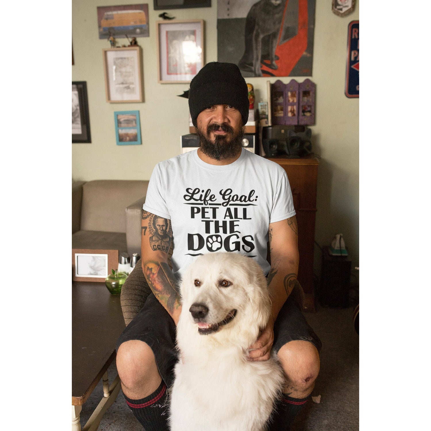 Man wearing a Tee shirt that says "Life Goal: Pet All The Dogs."