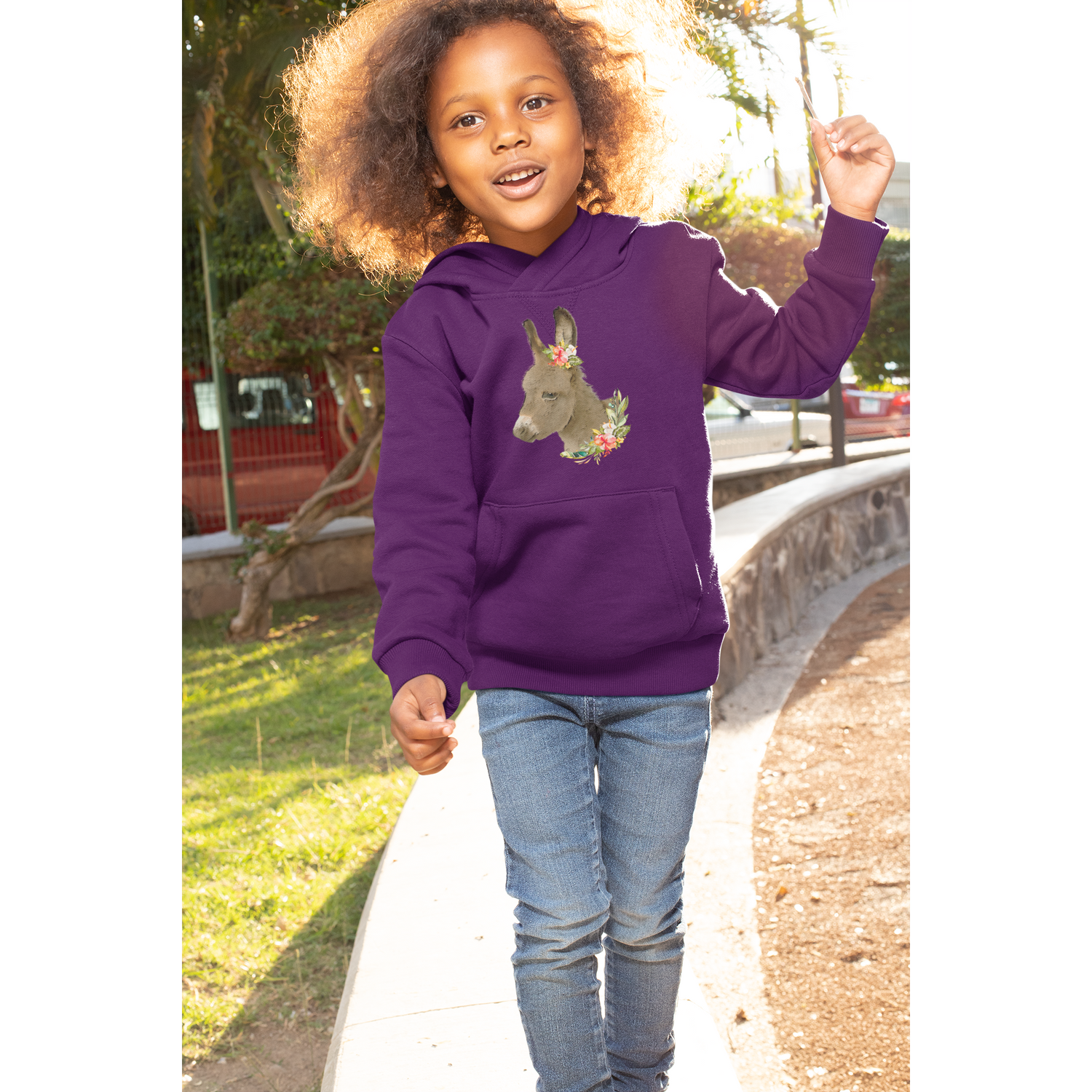 Girl wearing purple hoodie with Baby Donkey graphic
